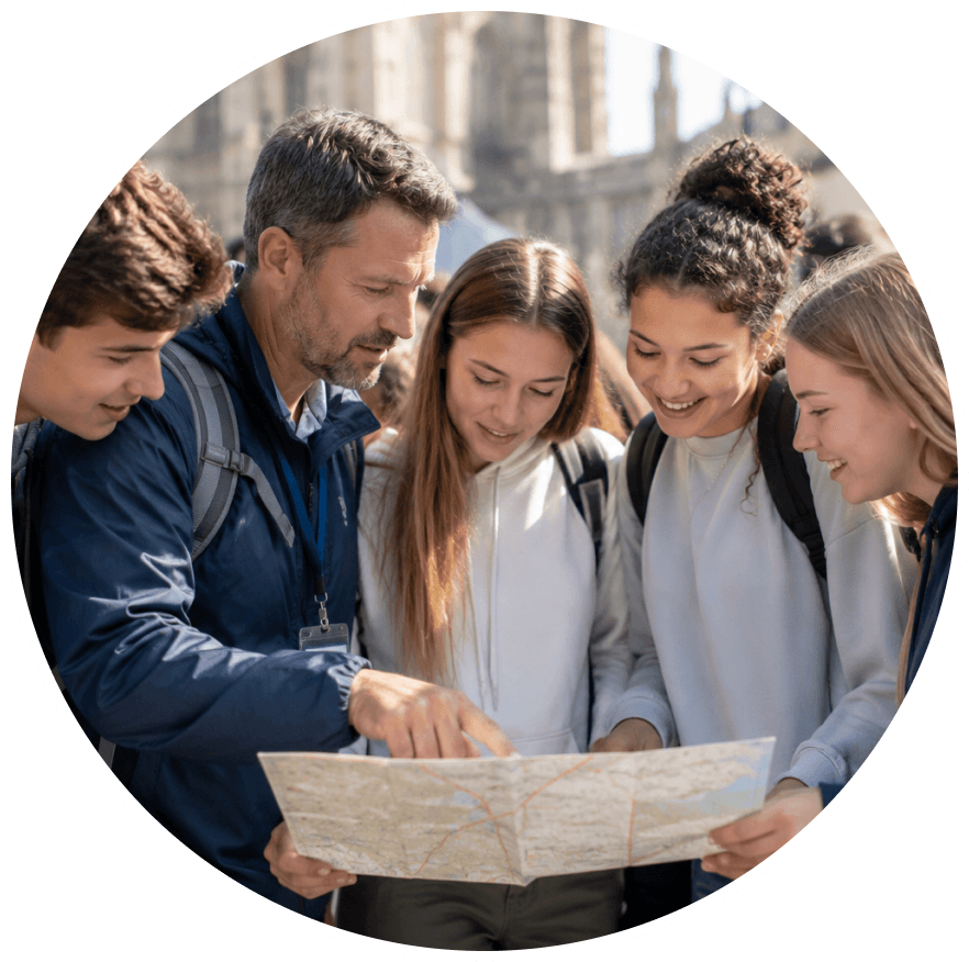 Dave Dagostino with students reviewing a trip map outdoors